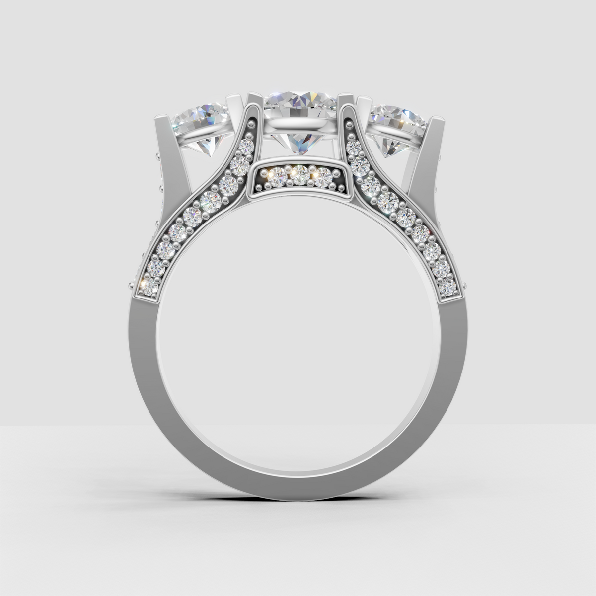 Three round diamond engagement ring with intricate pave gallery