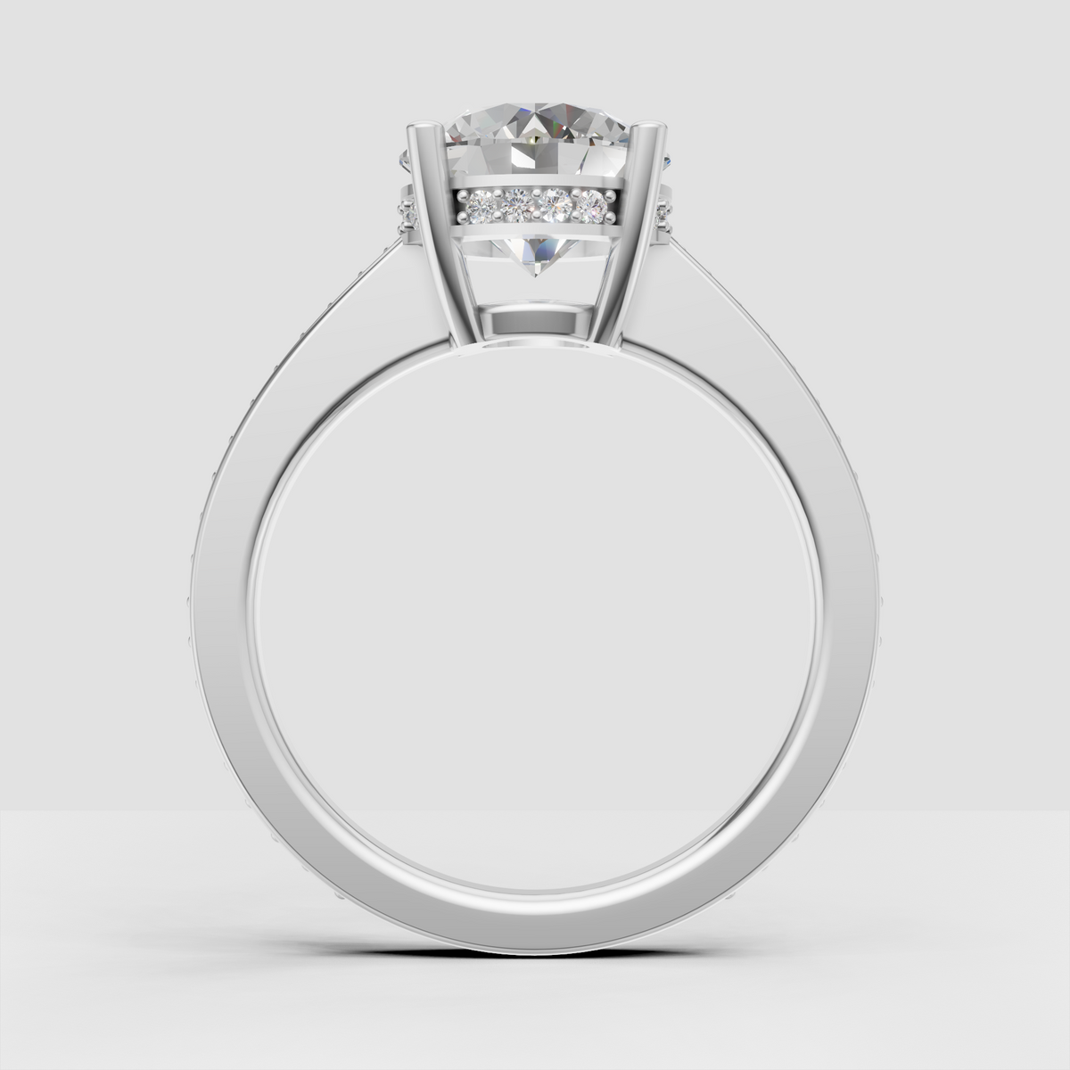 Close-up round diamond engagement ring with hidden halo detailing.