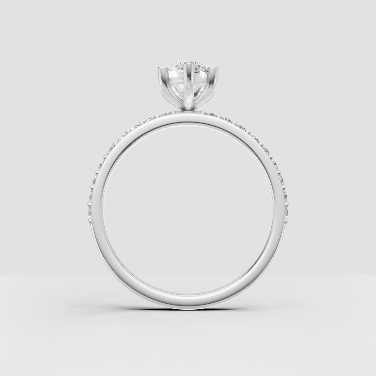 Marquise cut engagement ring featuring a delicate pave band