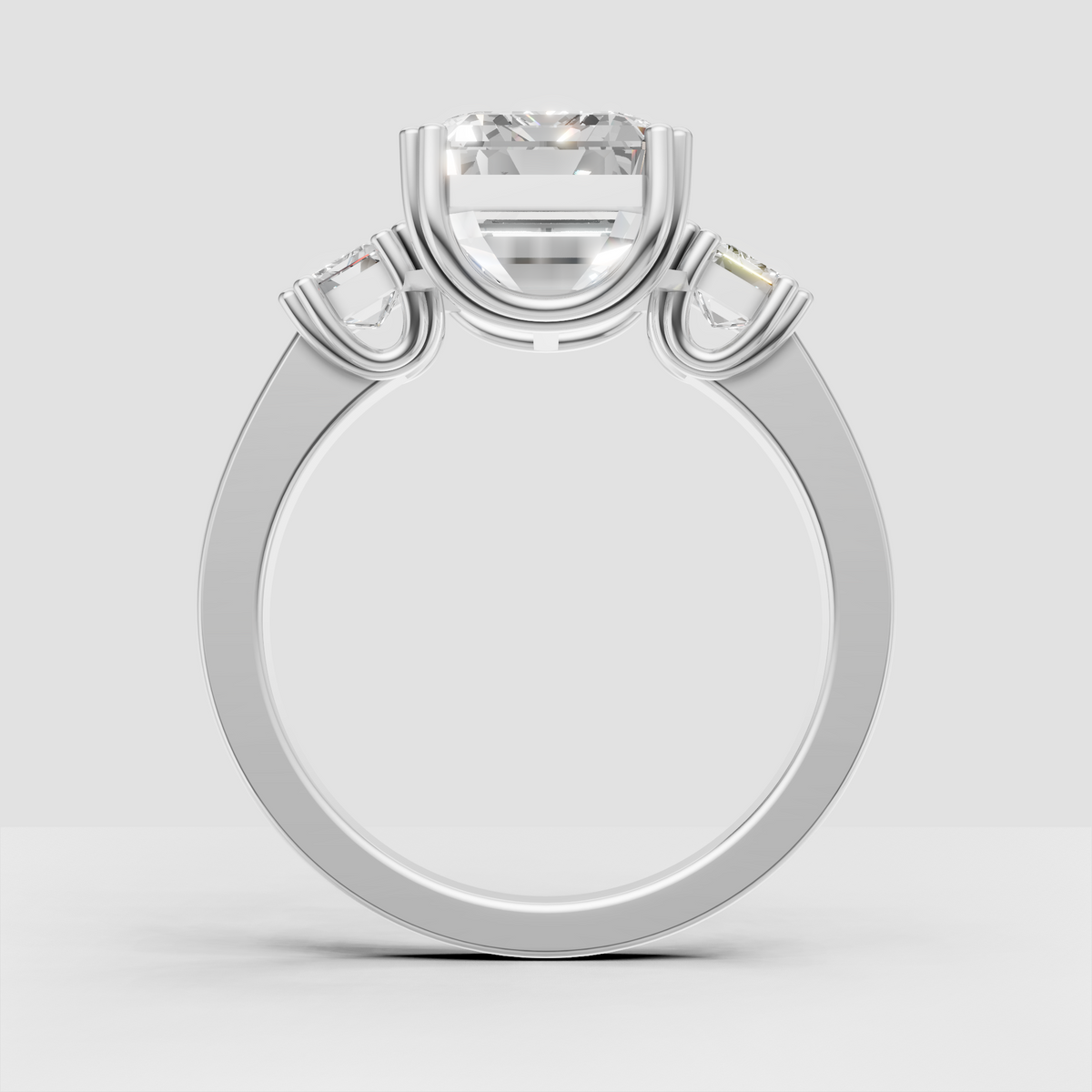 Emerald cut center stone and side stone engagement ring