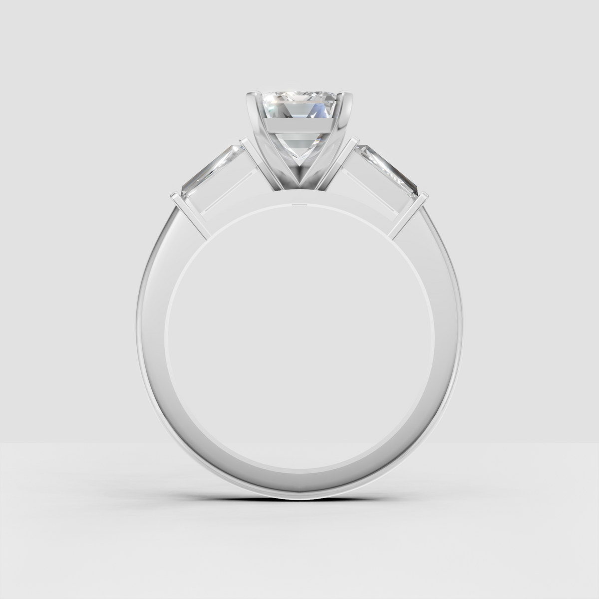 Close-up emerald cut diamond engagement ring with gold prongs and accents