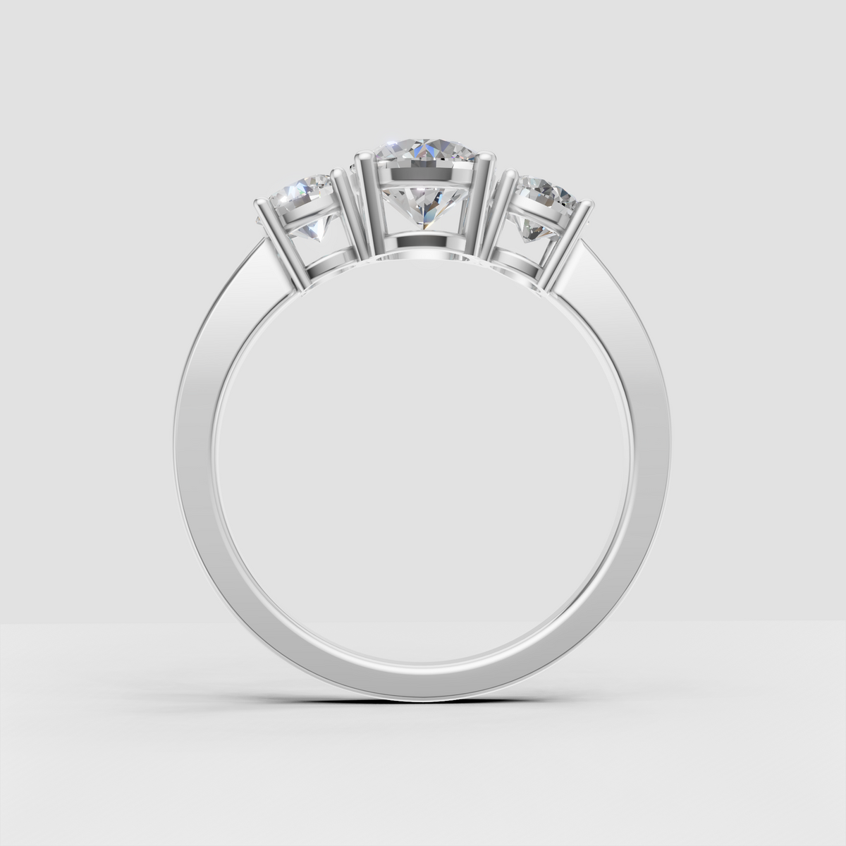 Side view of round Diamond three-stone engagement ring in yellow gold