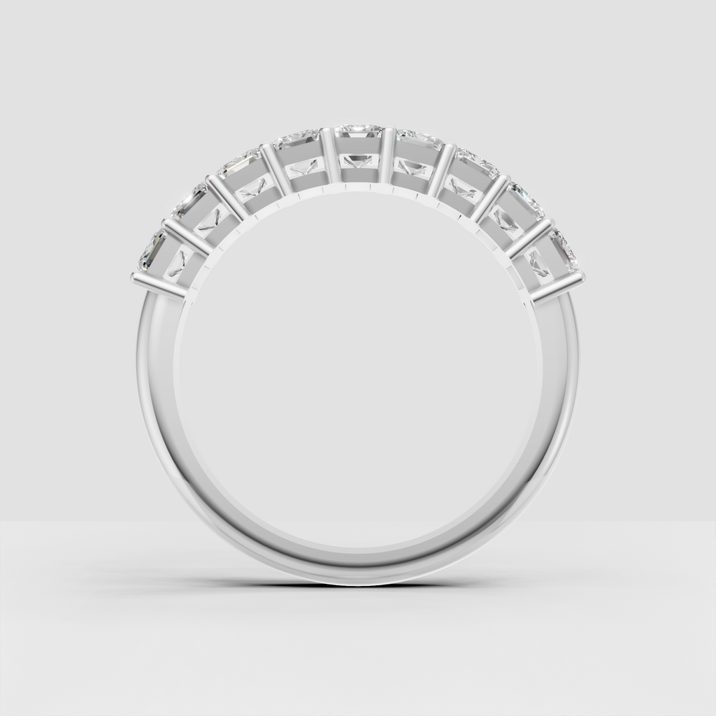 Modern emerald cut eternity ring with shared prongs