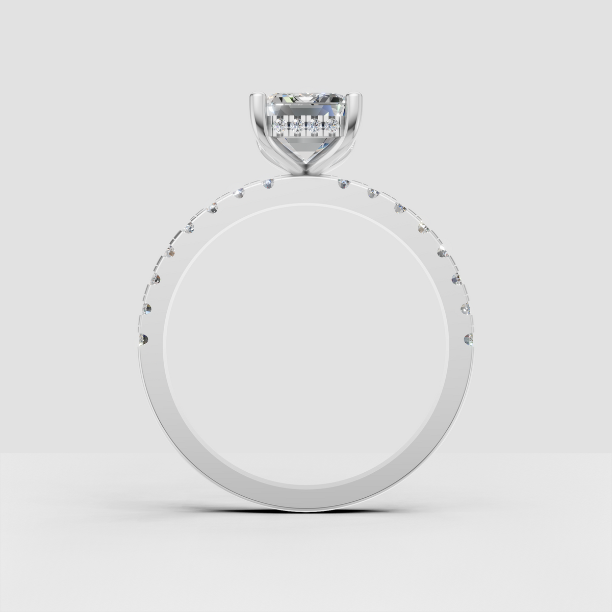 Step-cut emerald diamond ring with pavé-set shoulder stones