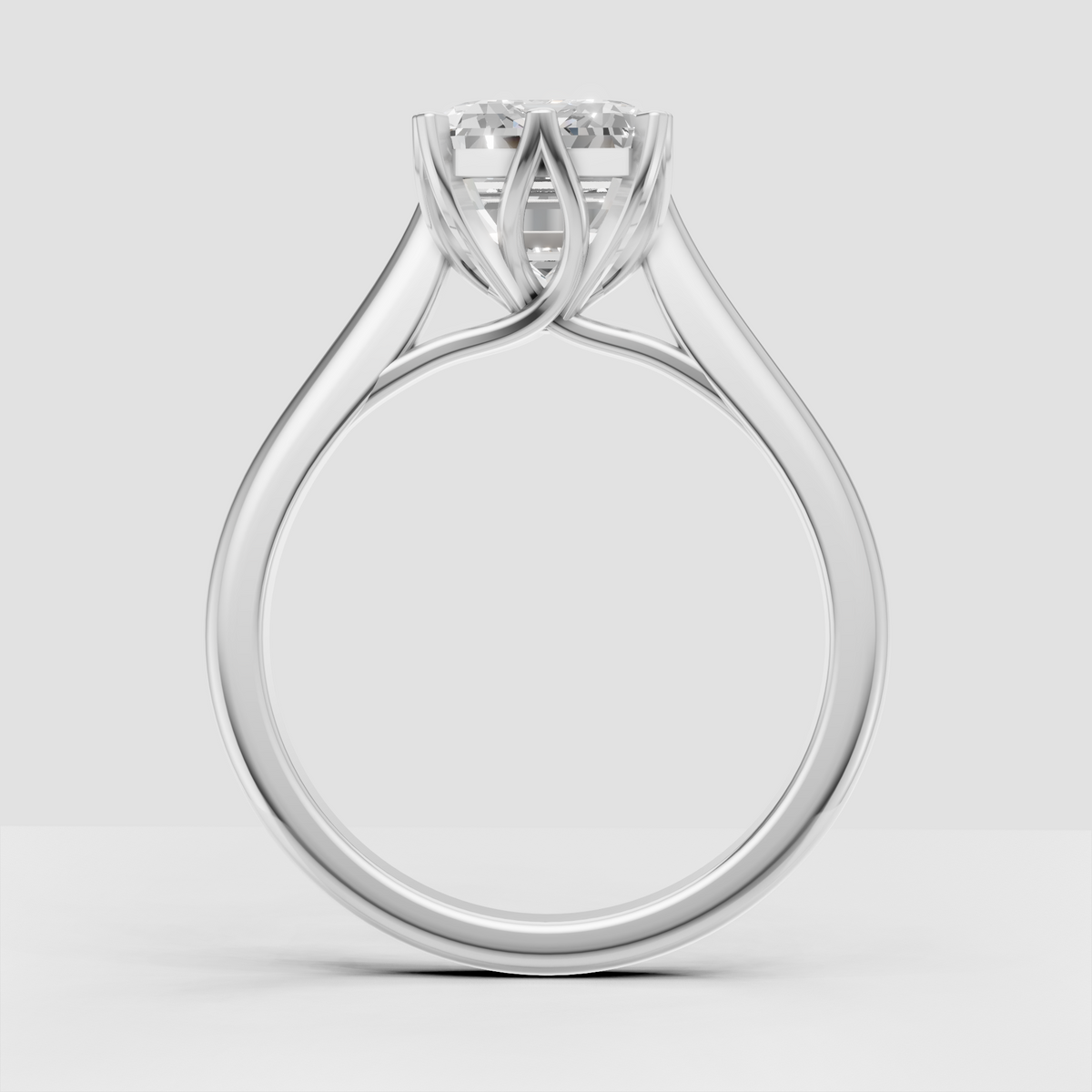 Emerald cut diamond ring with split shank and curved shoulders
