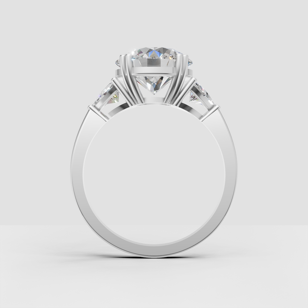 Round brilliant engagement ring with pear-shaped accent stones