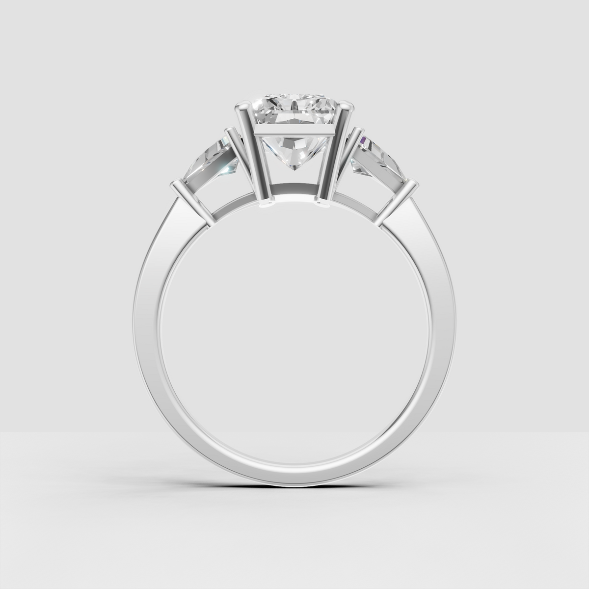 Radiant center diamond ring with tapered side stones and polished yellow gold band