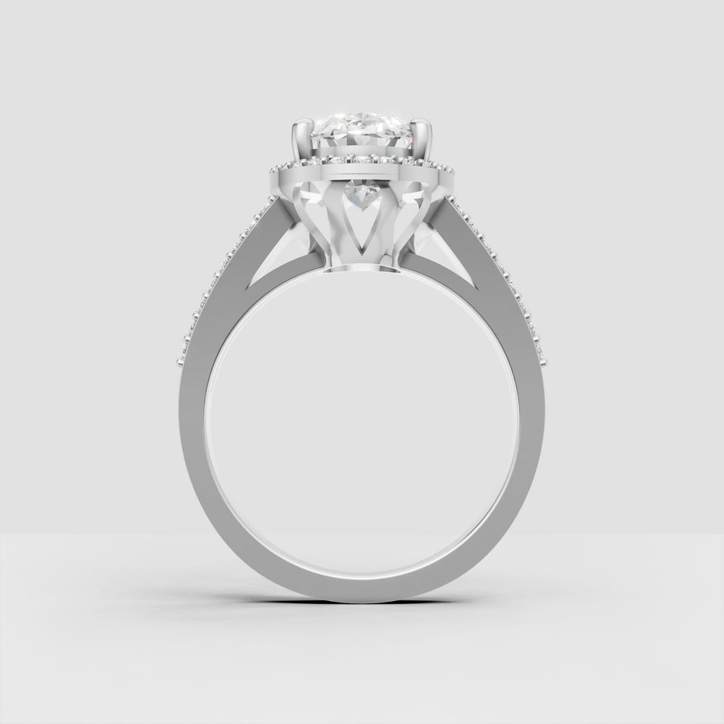 Yellow gold oval engagement ring with split shoulders and pavé stones.