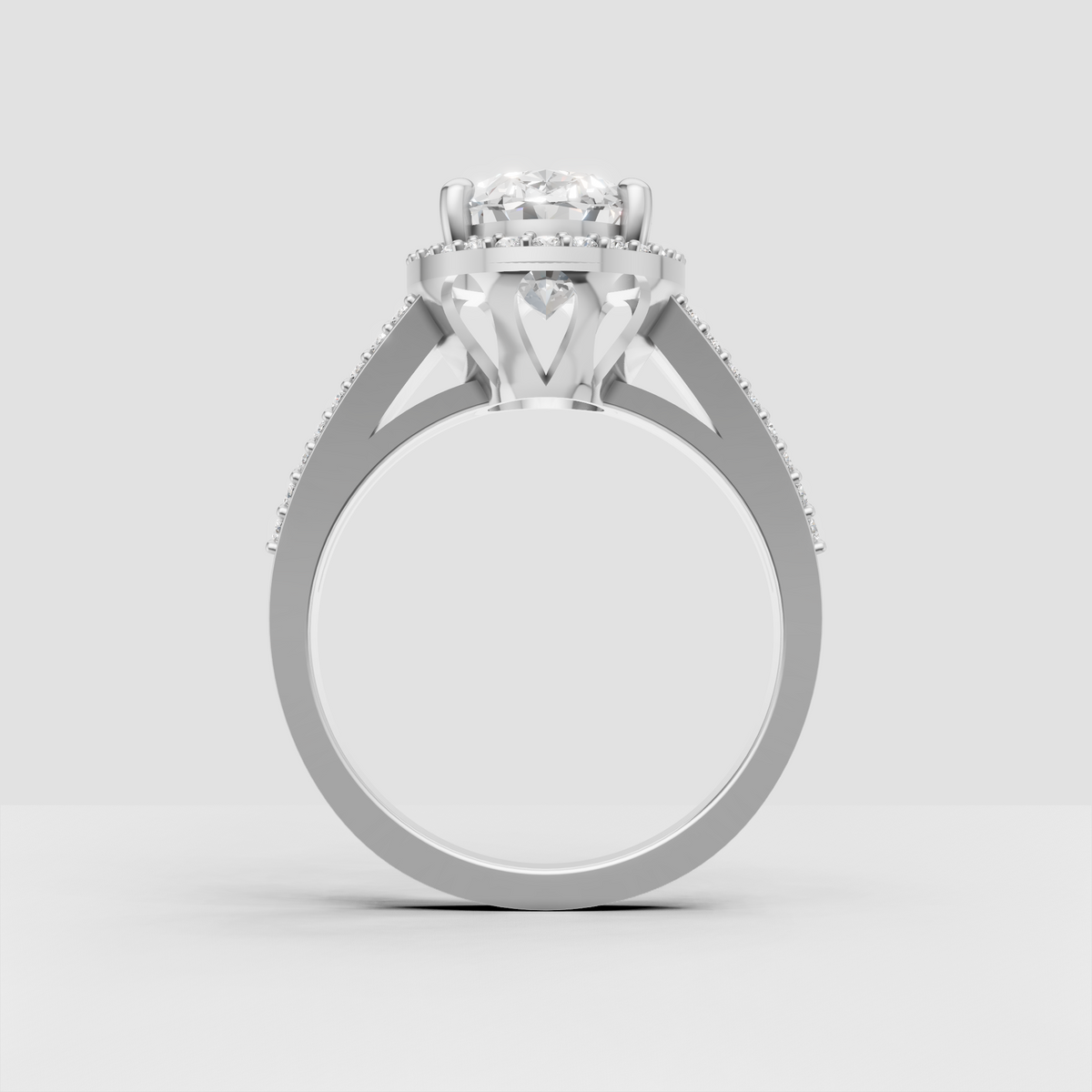 Yellow gold oval engagement ring with split shoulders and pavé stones.