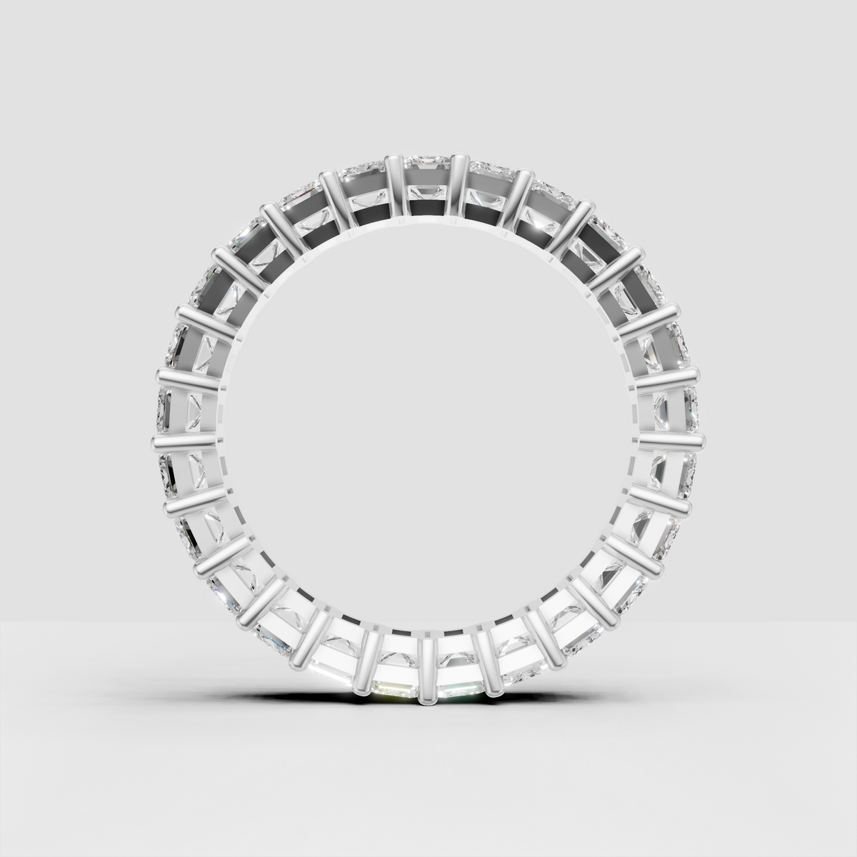 Wide emerald diamond eternity band with rounded gold prongs