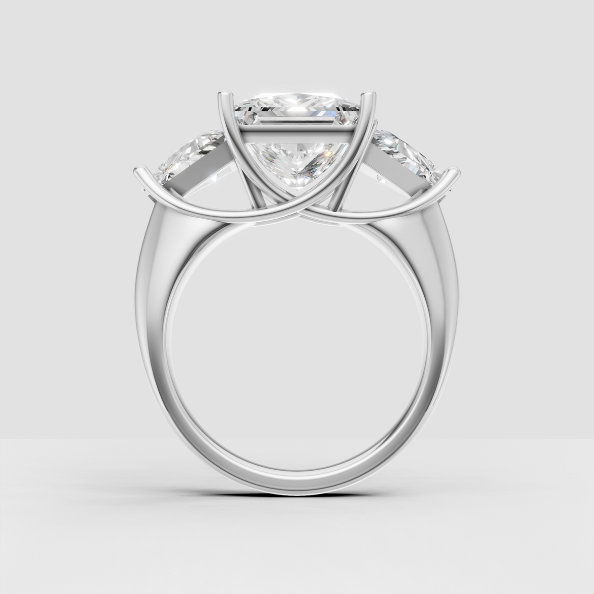 Princess cut center diamond with triangular side stones in gold