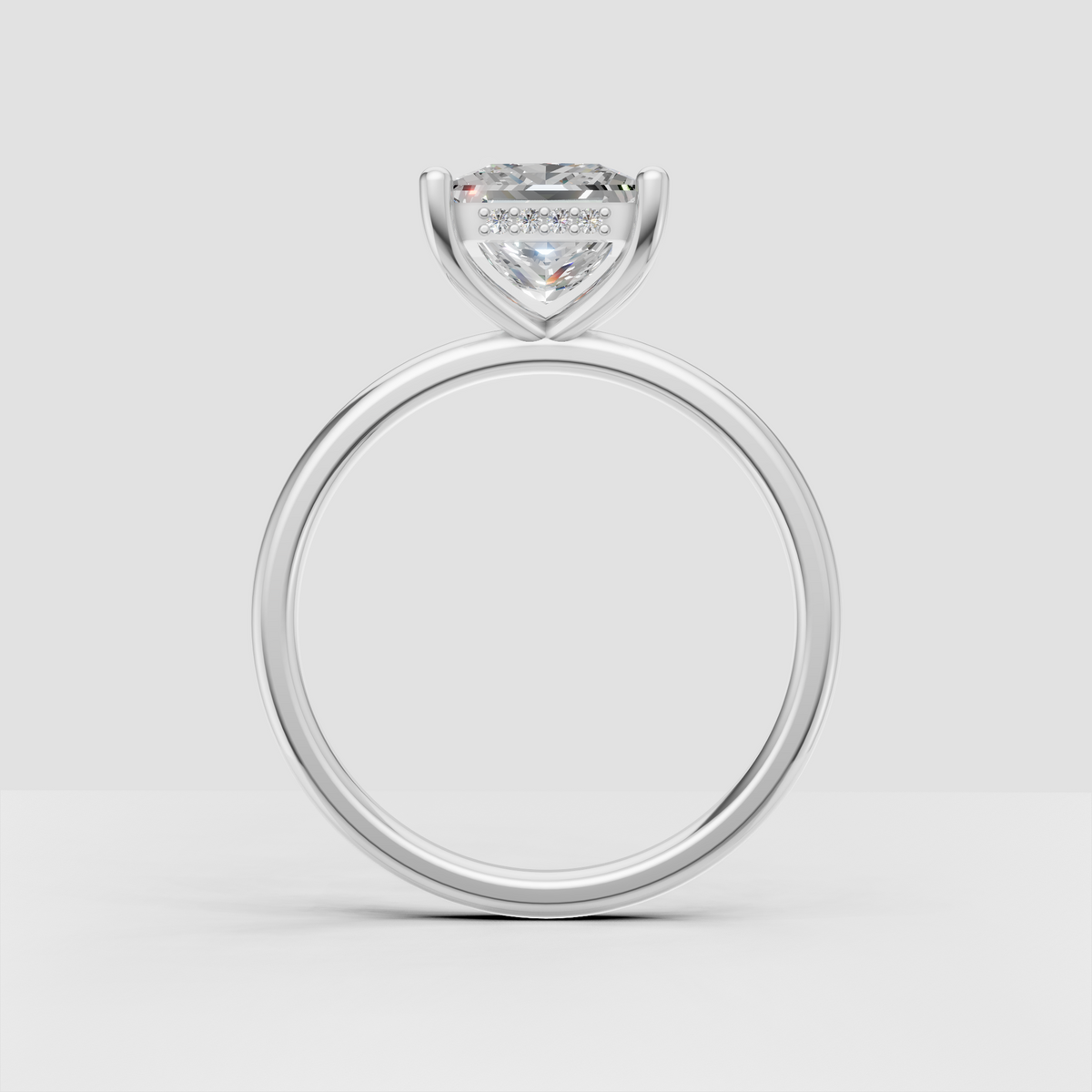 Detailed princess cut diamond engagement ring showing four-prong setting and sparkling under-gallery accents