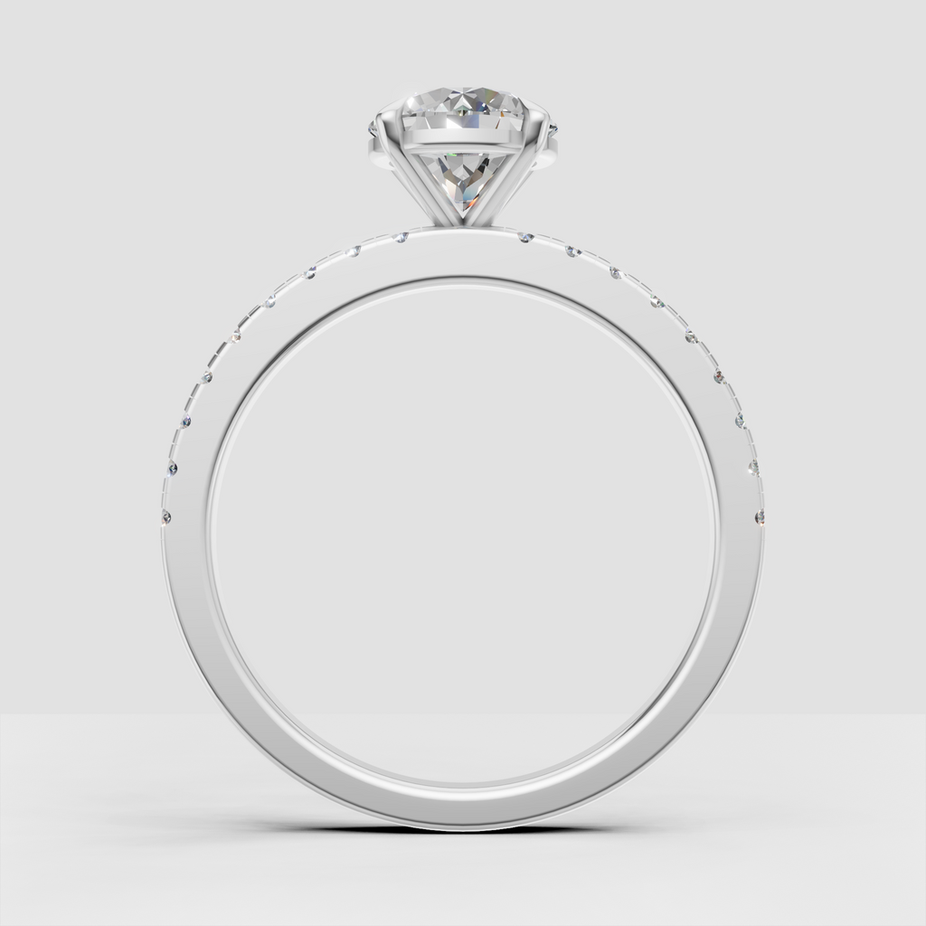 Round brilliant center stone in a four-claw yellow gold engagement ring setting
