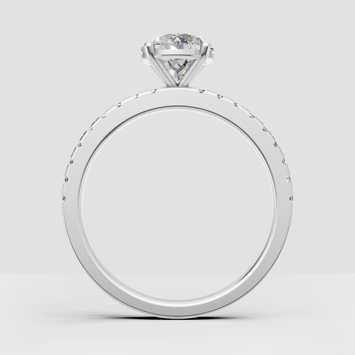 Round brilliant center stone in a four-claw yellow gold engagement ring setting