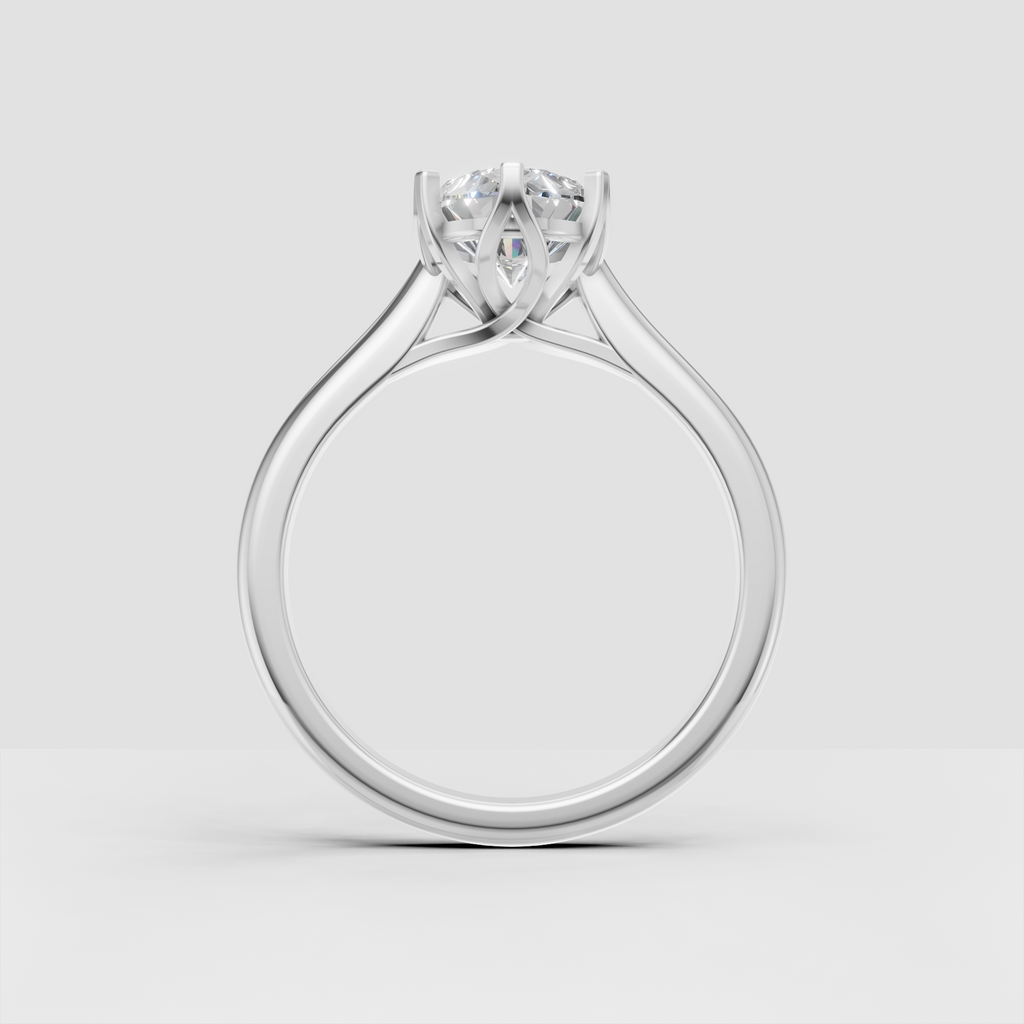 Side view of yellow gold pear diamond ring with open cathedral gallery
