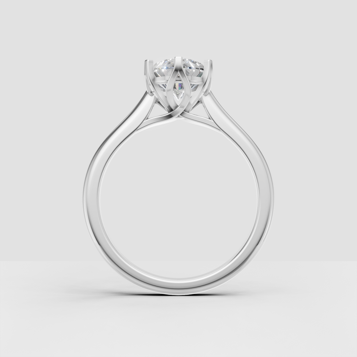 Side view of yellow gold pear diamond ring with open cathedral gallery