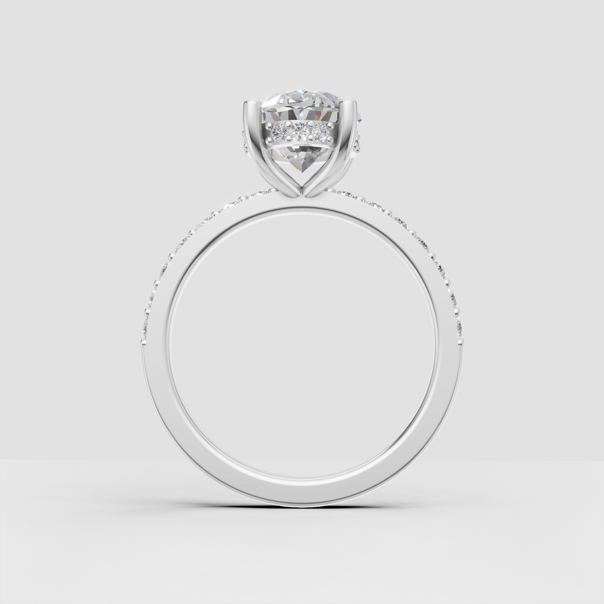 Classic oval cut bridal ring with pavé band and four prongs