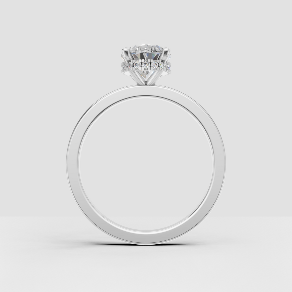 Oval engagement ring with elevated four-prong center setting