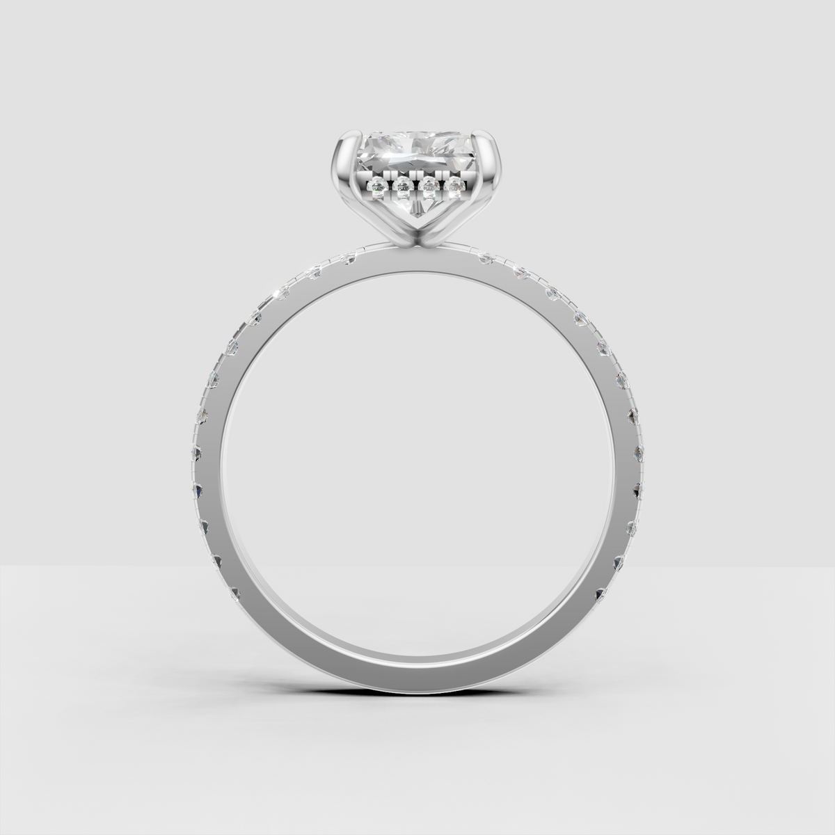 Close-up radiant diamond ring with detailed pave band