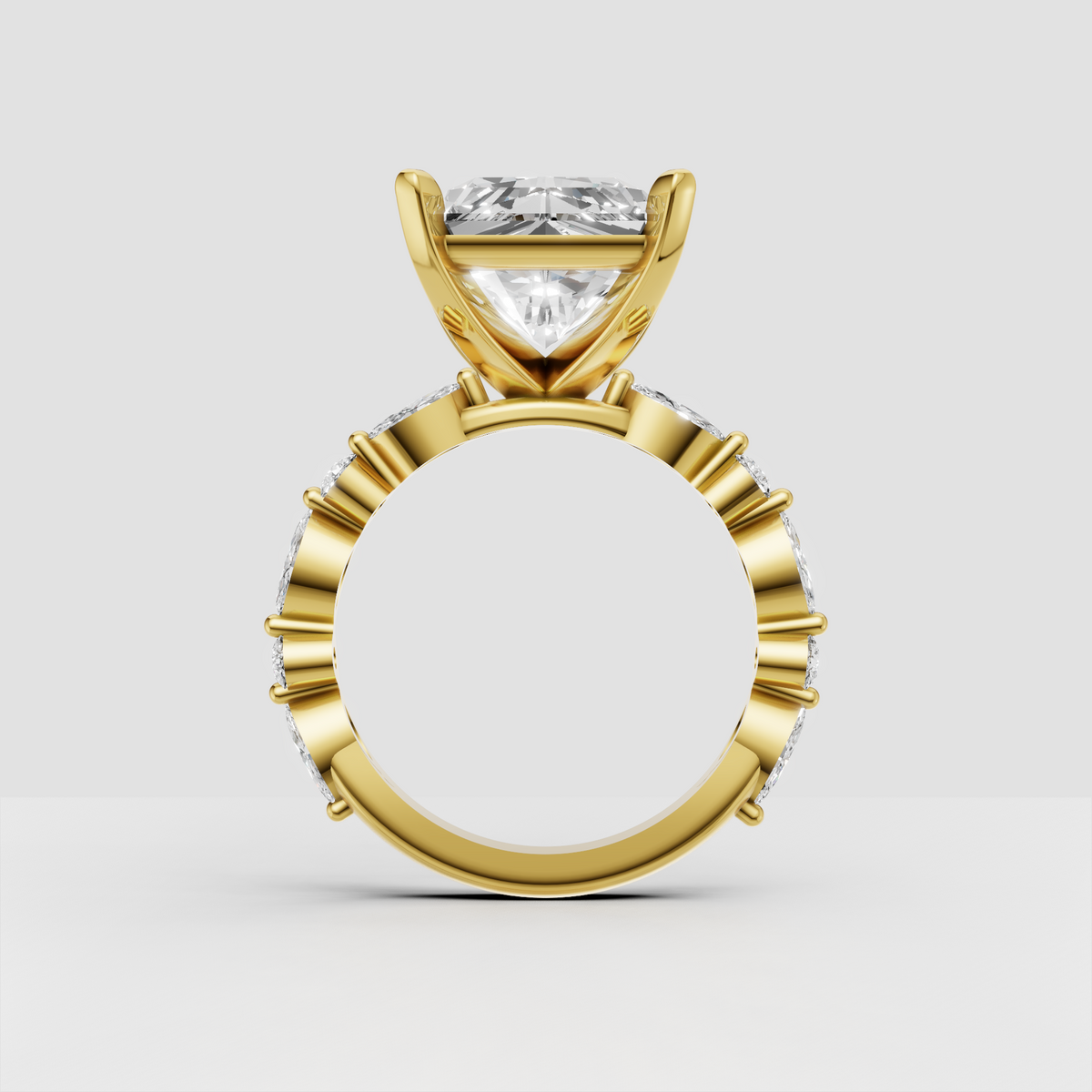 Yellow gold radiant diamond ring with graduated round and marquise side stones