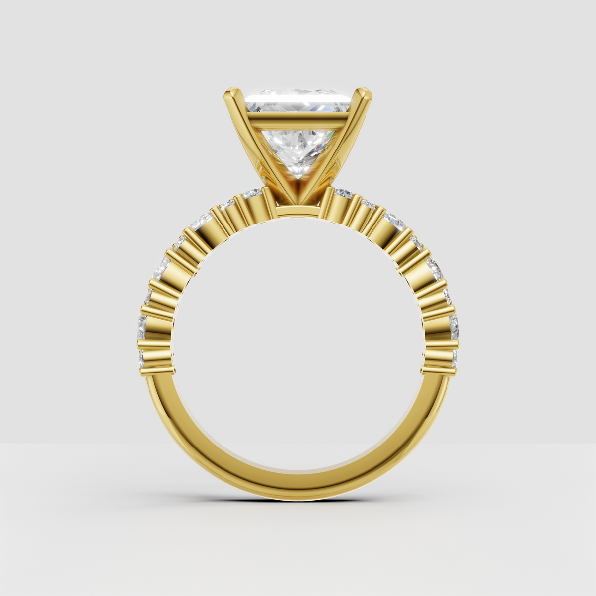 Yellow gold princess cut engagement ring with pavé-inspired diamond shoulders