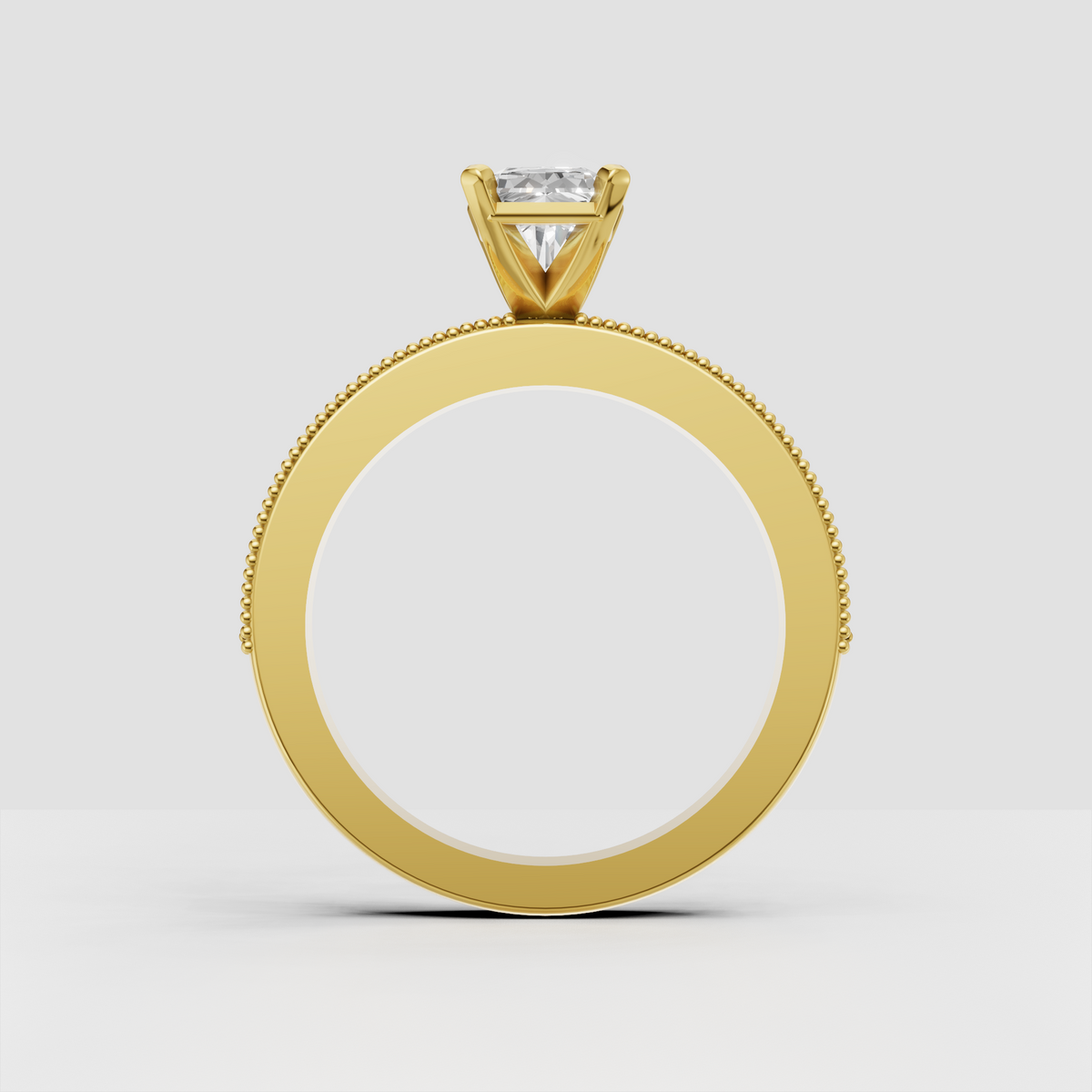 Radiant cut center diamond ring with four-prong claw setting and beaded milgrain edges