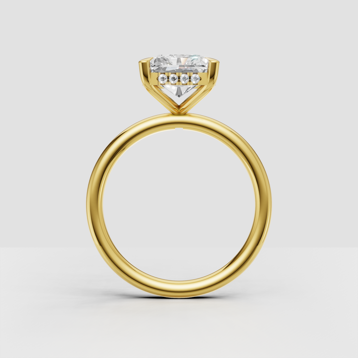 Yellow gold radiant cut solitaire engagement ring with four prongs