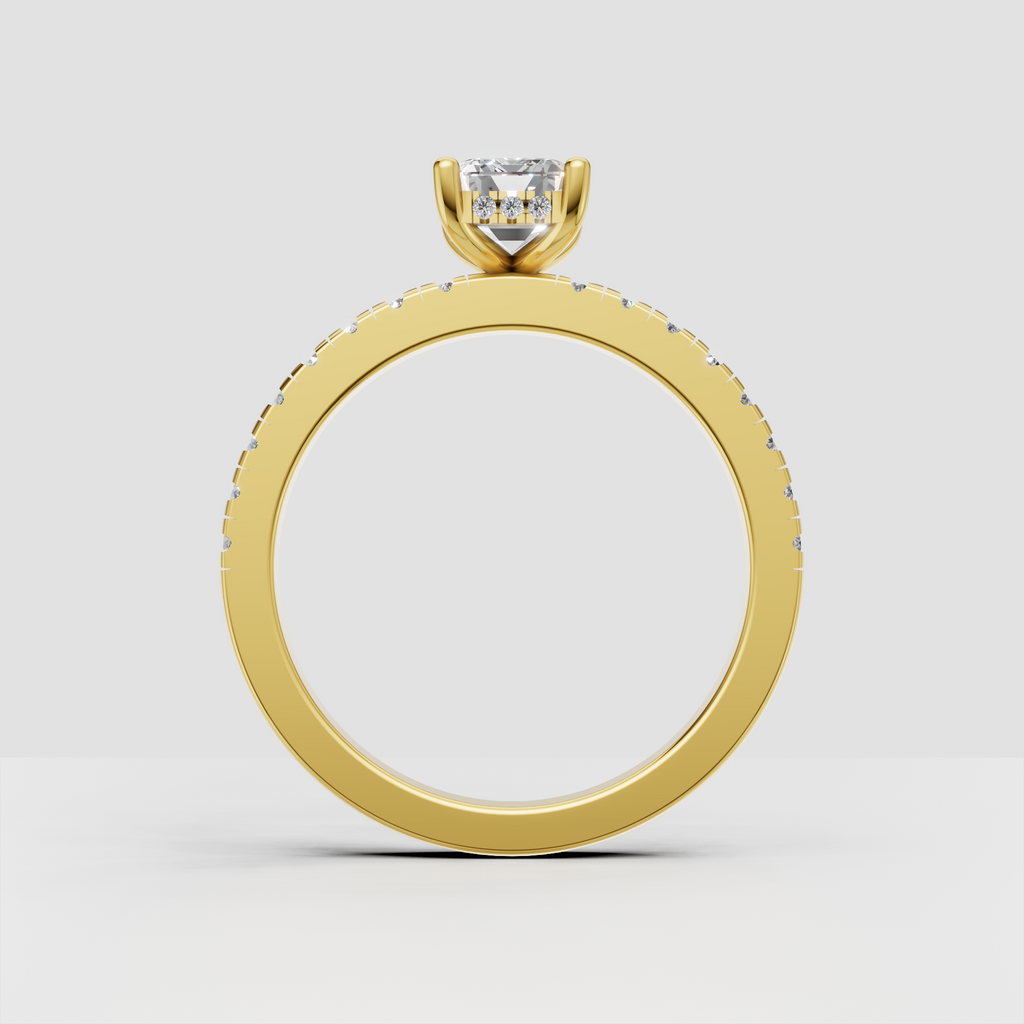 Emerald cut diamond ring featuring round pave side stones and yellow gold band