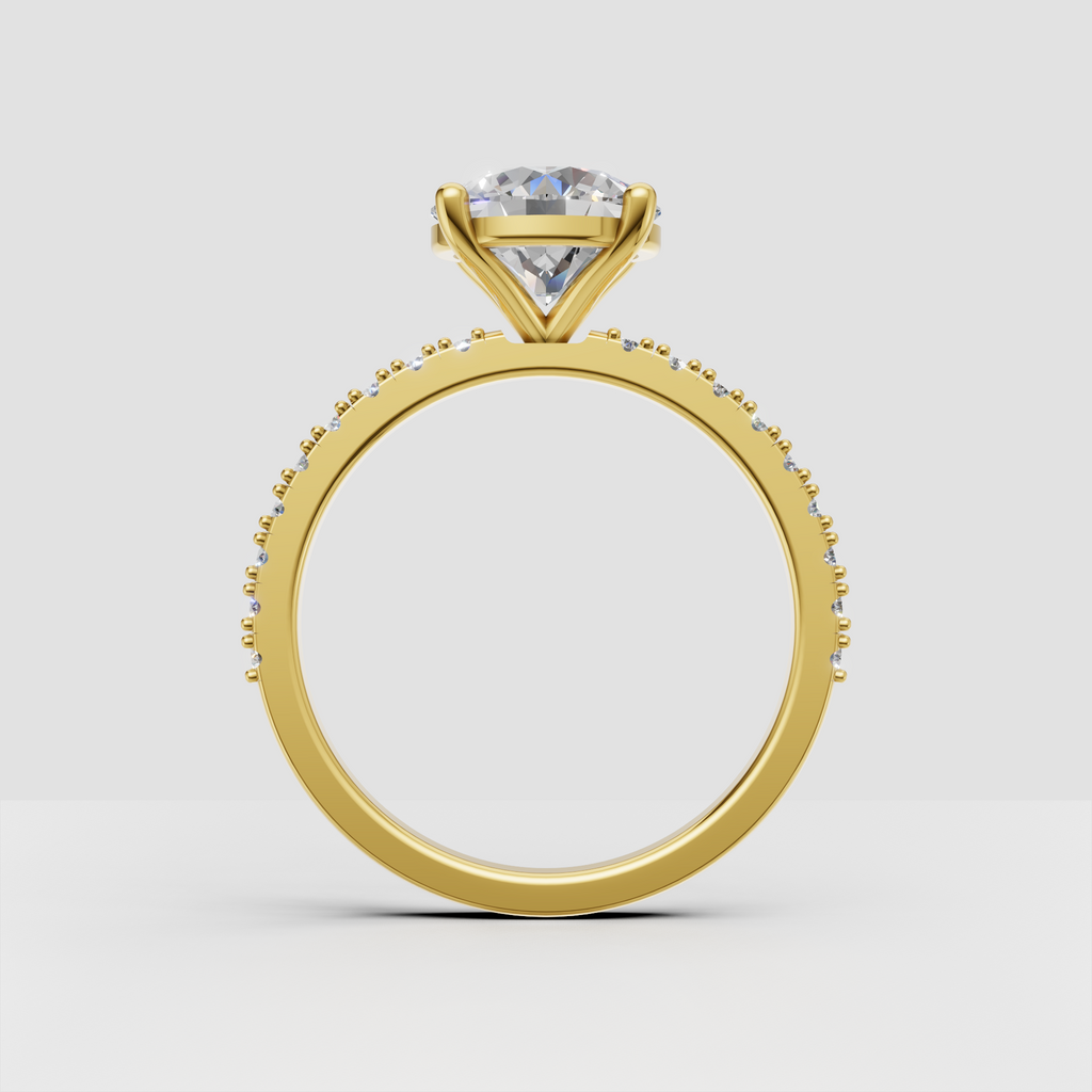 Round diamond ring featuring round pave stones along the shoulders