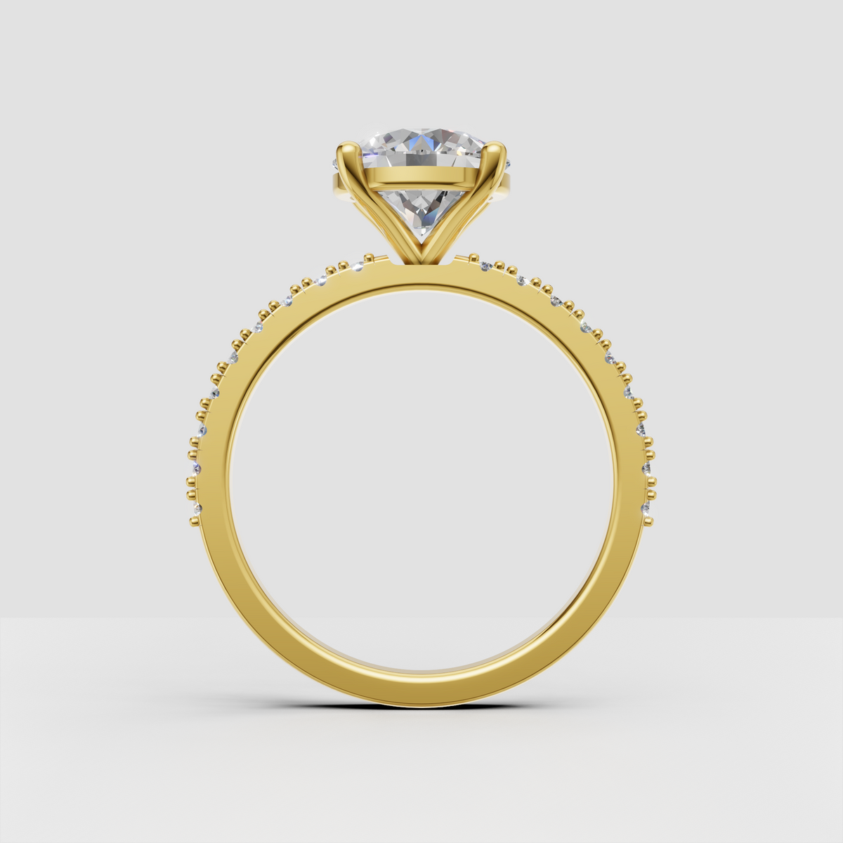 Round diamond ring featuring round pave stones along the shoulders