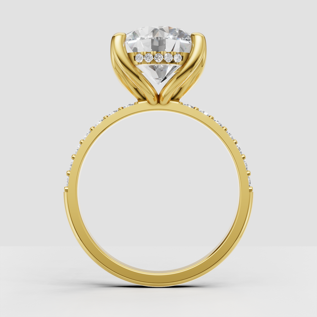 Round brilliant Diamond ring featuring a four-prong cathedral setting and pavé shoulders