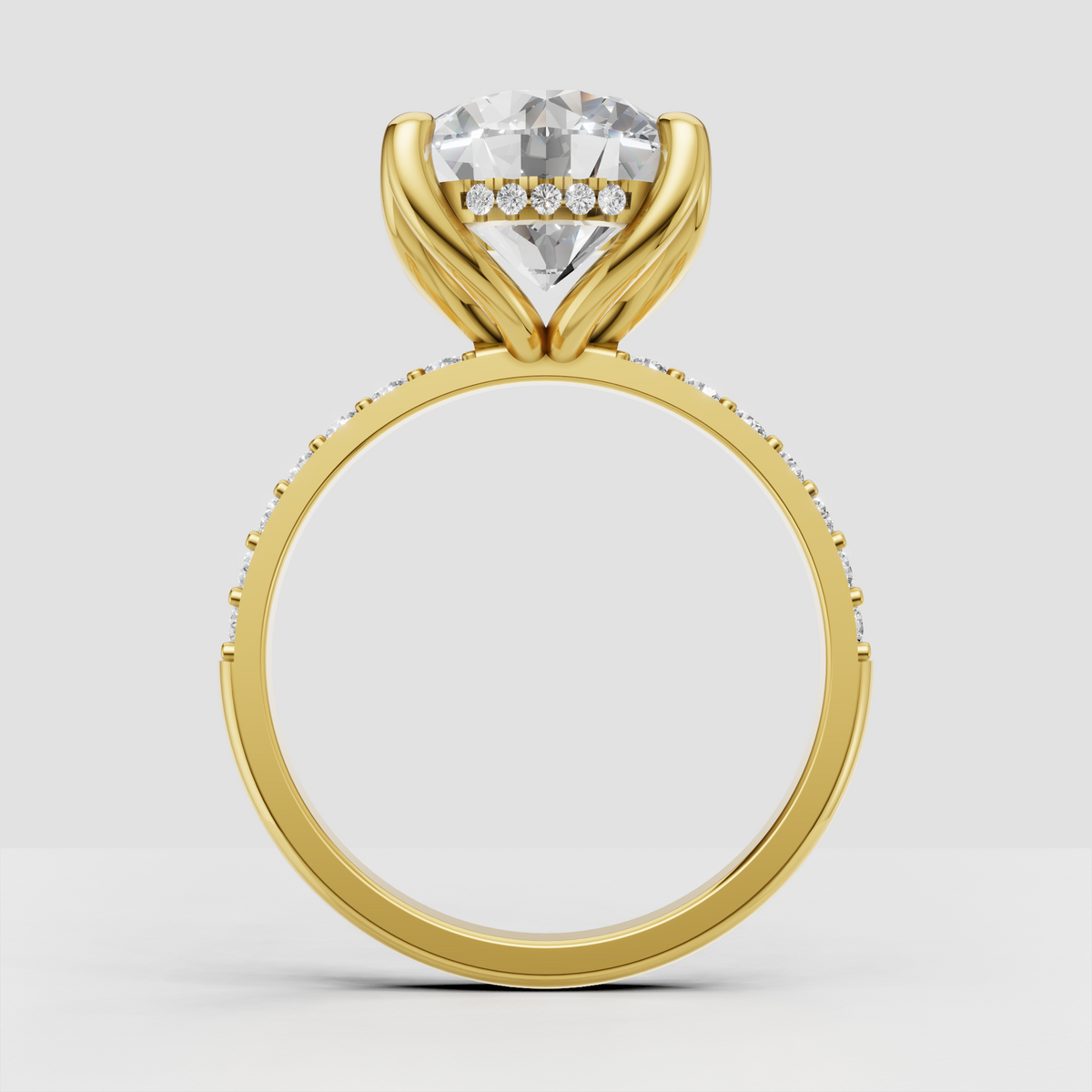 Round brilliant Diamond ring featuring a four-prong cathedral setting and pavé shoulders
