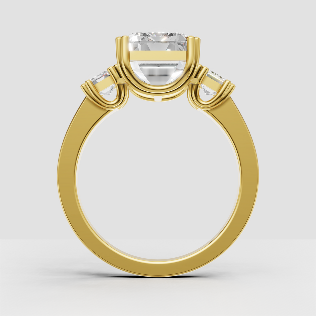Yellow gold emerald cut three stone engagement ring