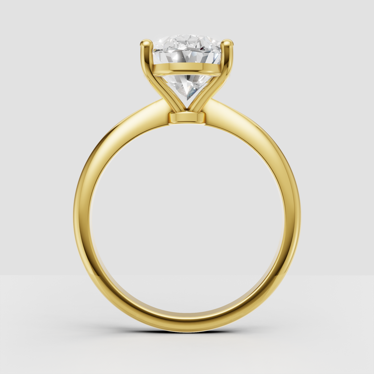 Oval brilliant Diamond ring featuring a smooth tapered yellow gold band