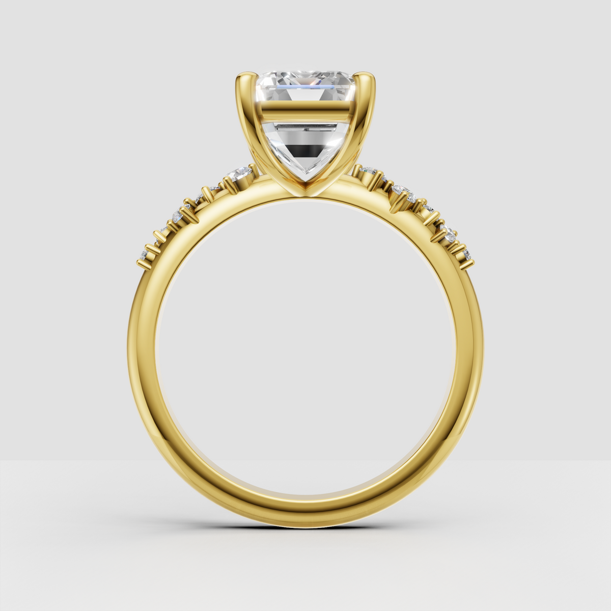Four-prong emerald cut diamond ring with polished gold band