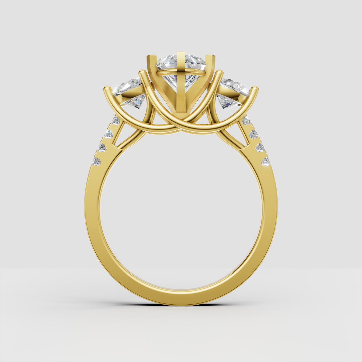 Pear cut diamond ring with round diamond side stones and yellow gold band