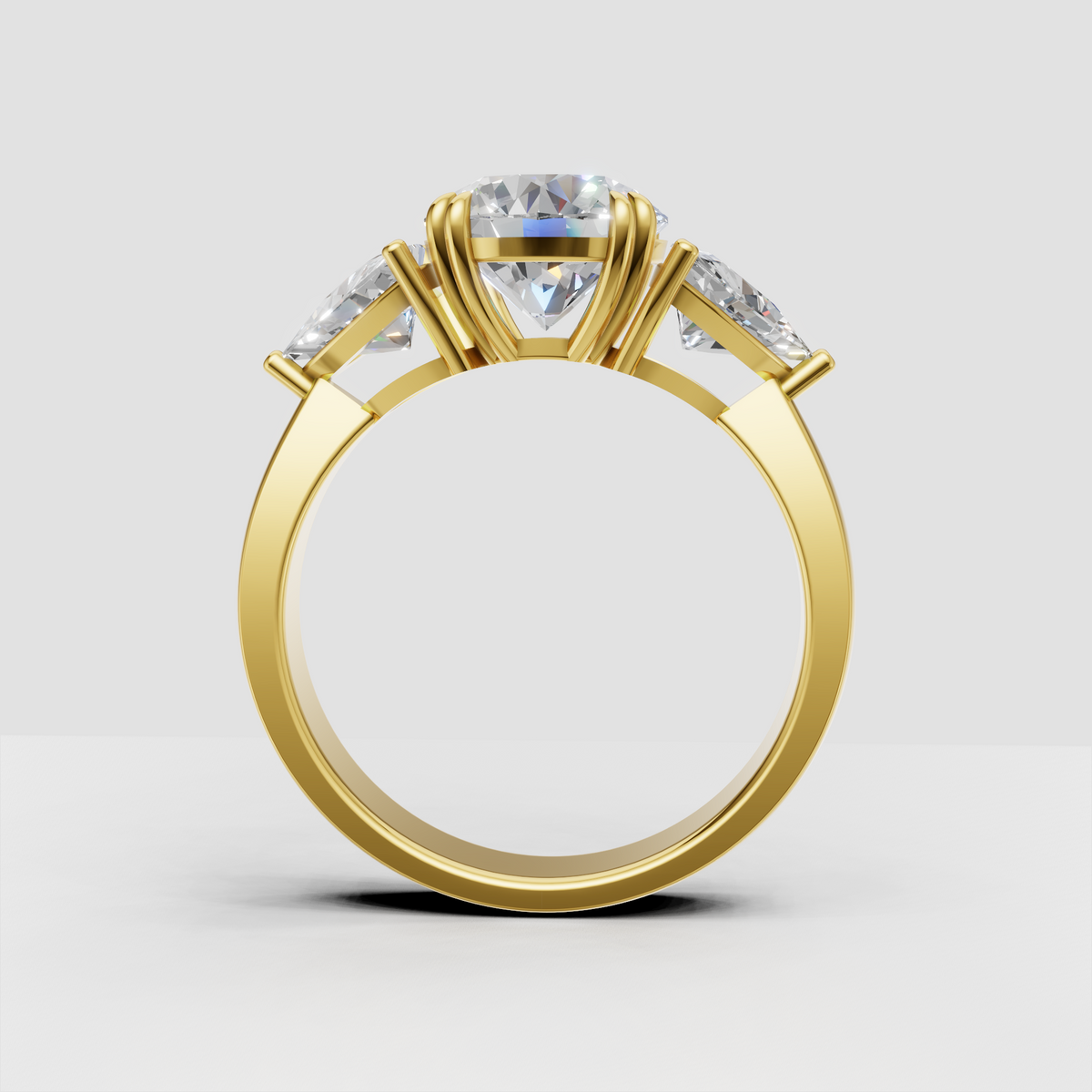 Gold round diamond ring featuring matching Trillion side stones
