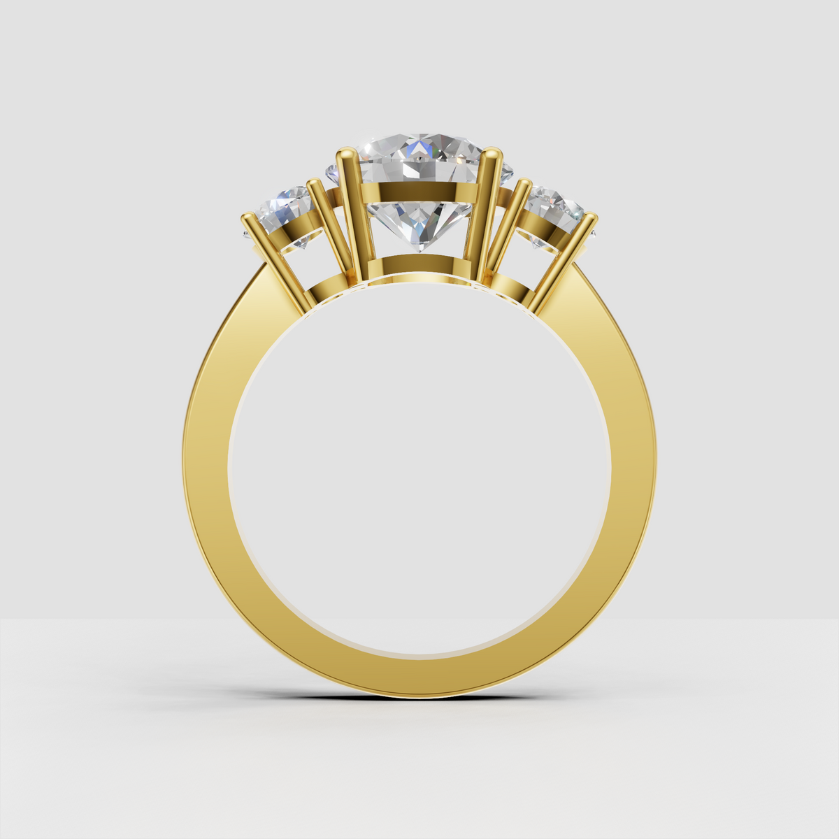 Three stone engagement ring featuring round diamonds