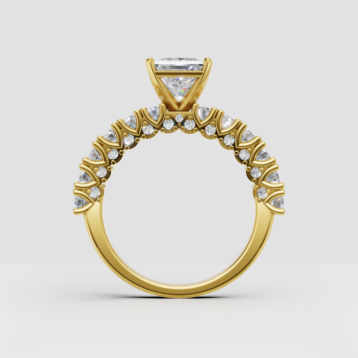 Princess diamond ring featuring a detailed yellow gold pavé band