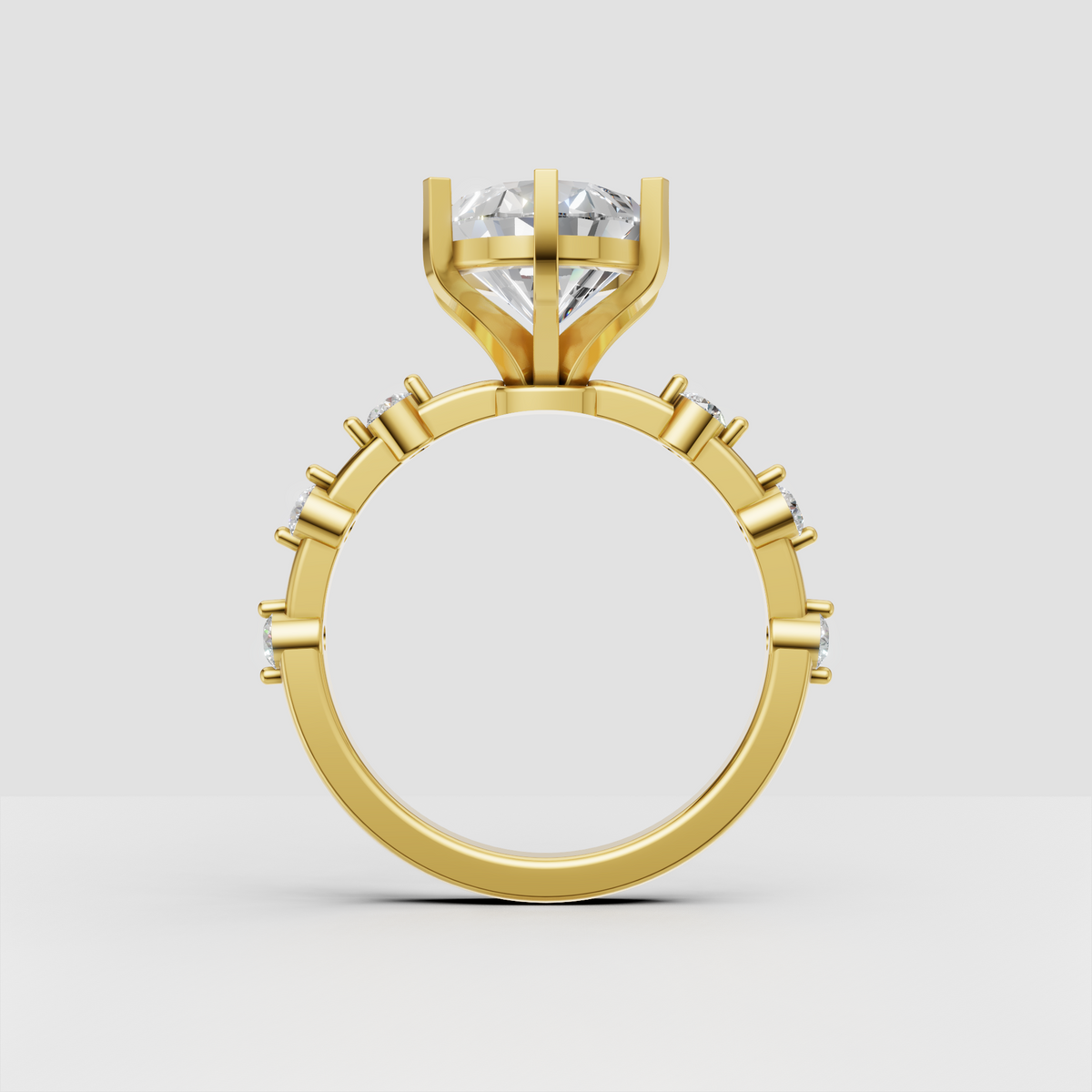 Yellow gold pear diamond ring with sparkling side stones
