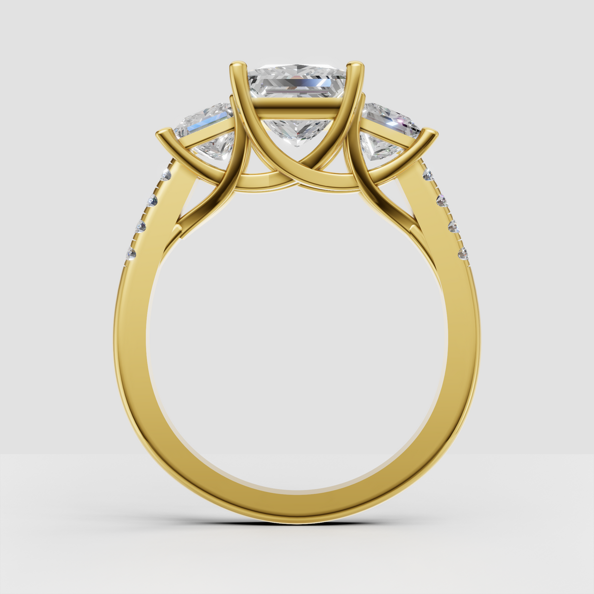 Princess cut diamond ring featuring matching side stones and polished gold setting