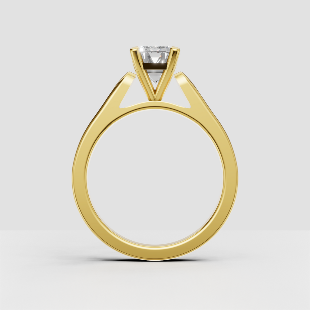 Emerald cut engagement ring with pavé side stones along the shoulders.