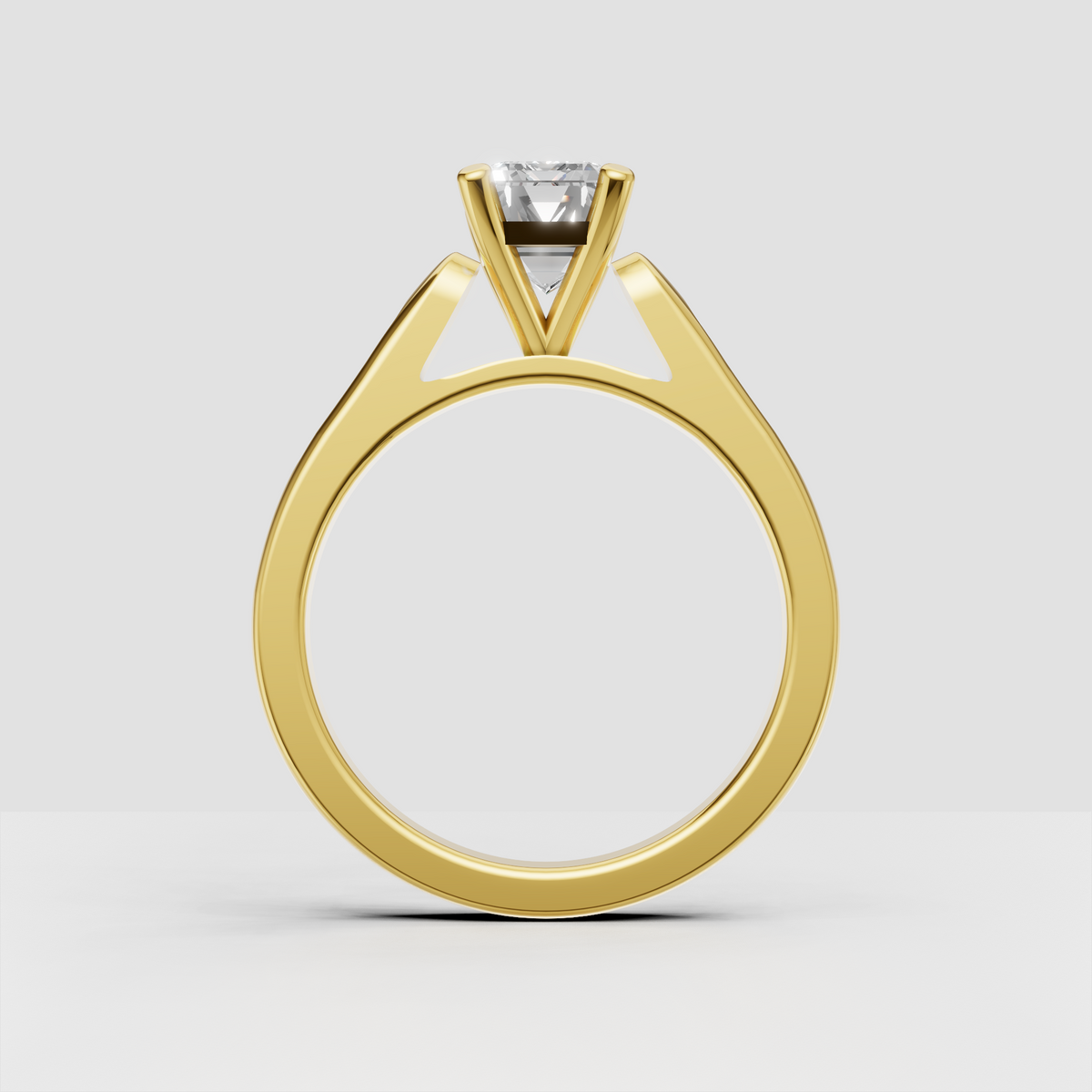 Emerald cut engagement ring with pavé side stones along the shoulders.
