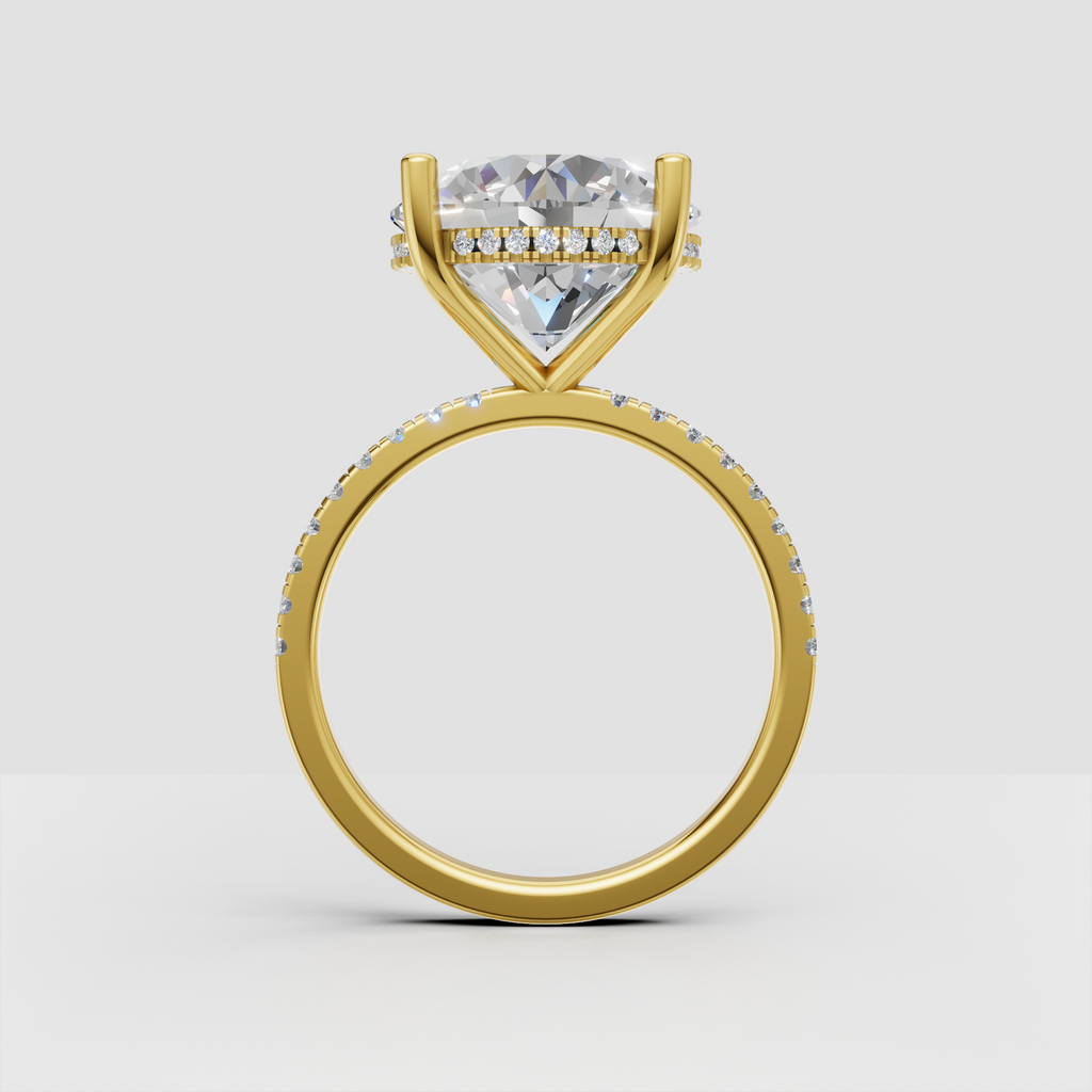 Side view of round diamond engagement ring showing hidden halo beneath the center stone and pavé shoulders.