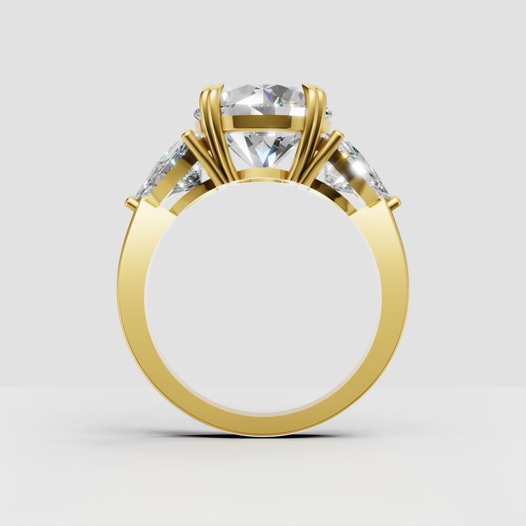 Round center diamond ring featuring pear shaped side diamonds and polished gold band