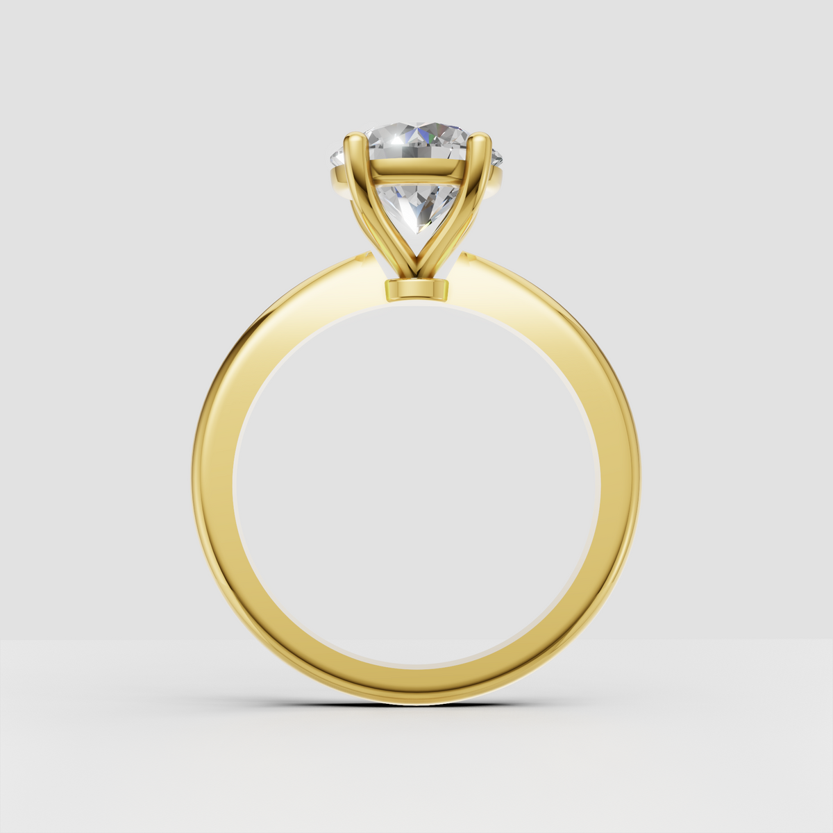 Yellow gold round diamond solitaire engagement ring with tapered band
