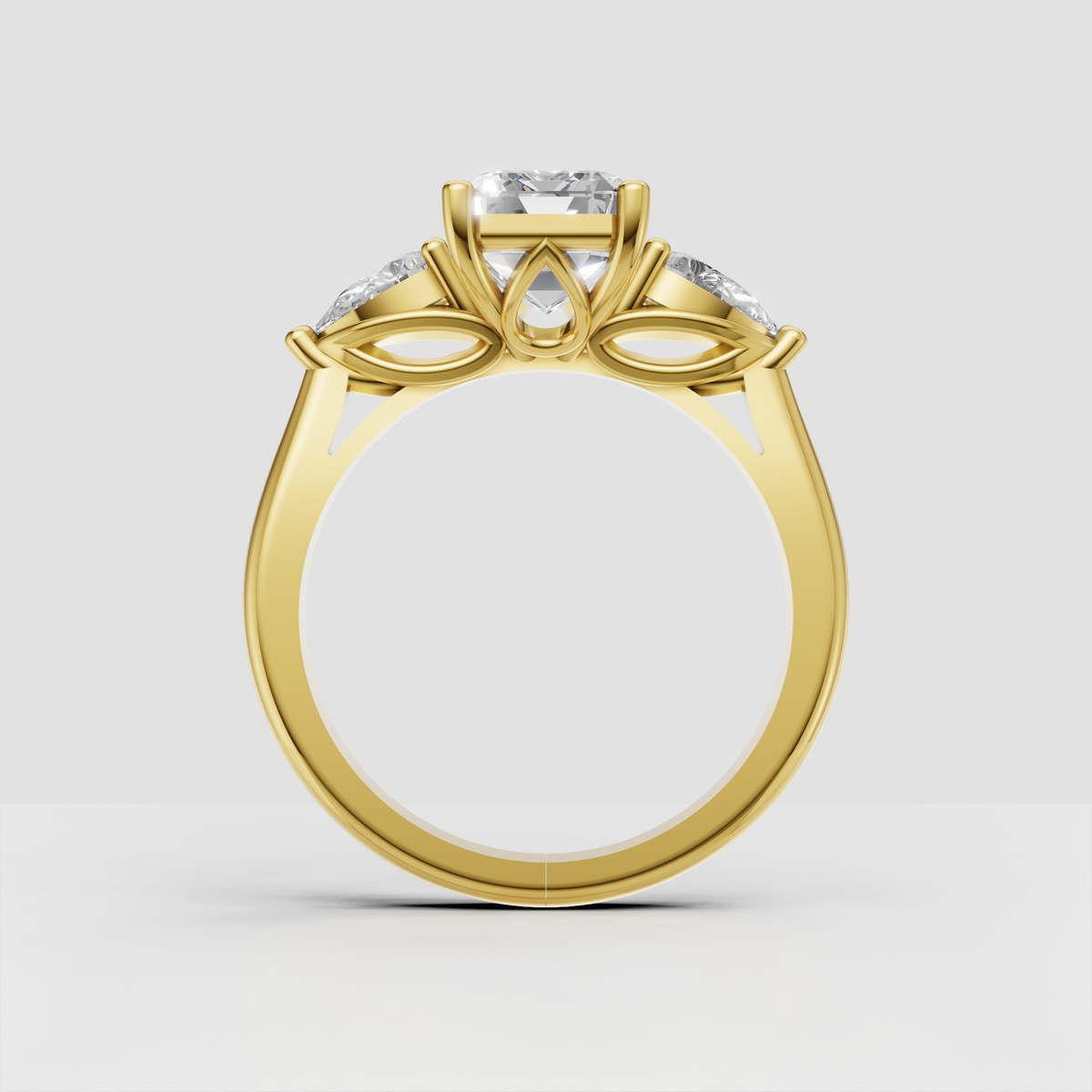 Three stone emerald cut diamond engagement ring