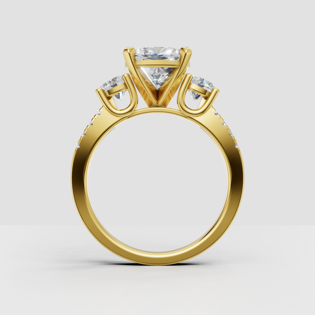 Yellow gold oval diamond engagement ring with two side stones