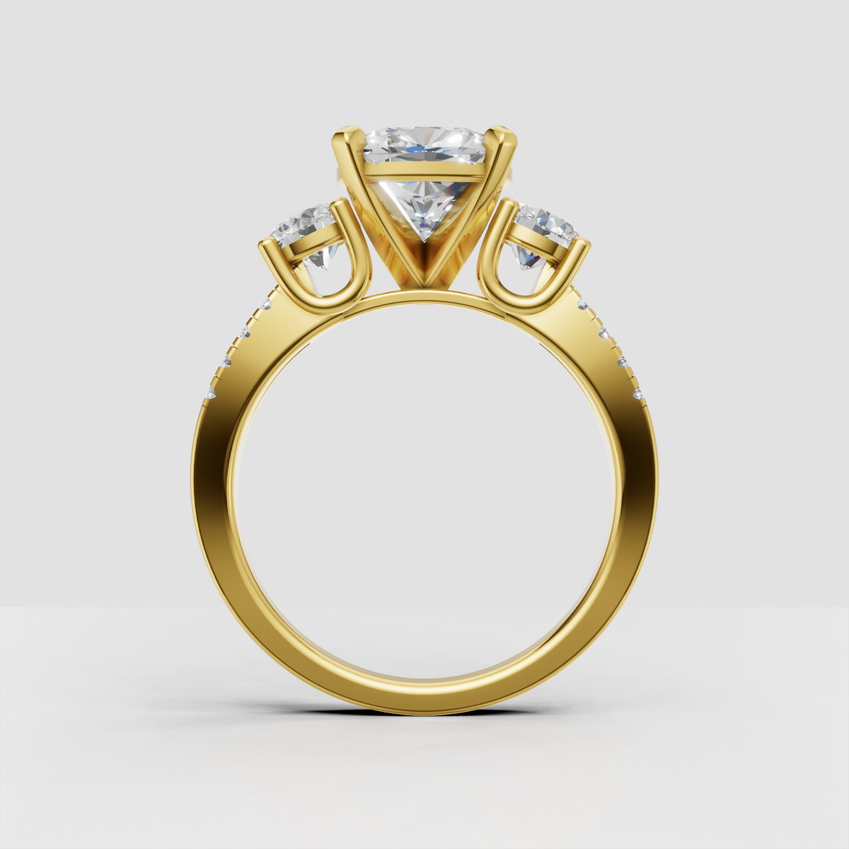 Yellow gold oval diamond engagement ring with two side stones
