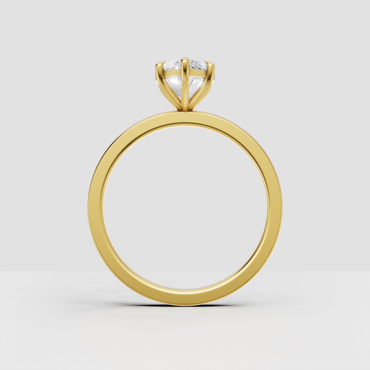 Marquise center stone engagement ring in polished gold setting